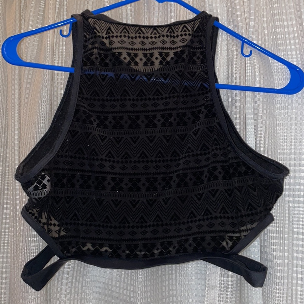 Black sports bra with back mesh design. Side cut outs